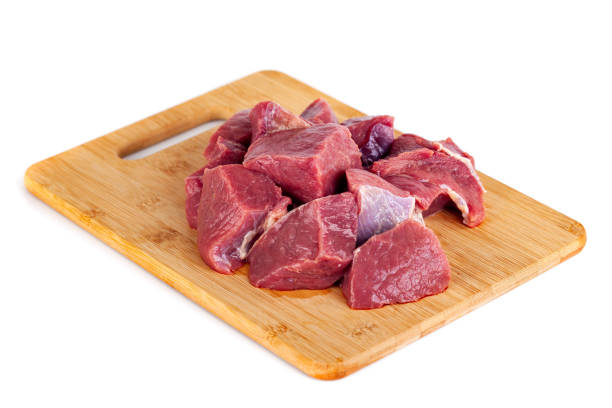 istock Chopped raw meat on wooden board isolated on white background 1226047725