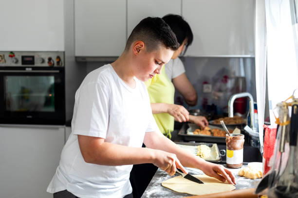 istock Teenage boy cooking at home 1226047913