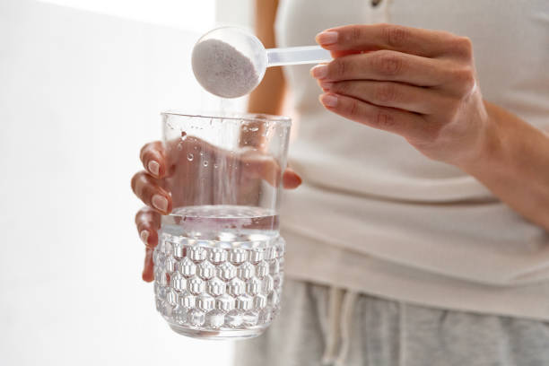 istock Young woman taking supplements at home 1226051238