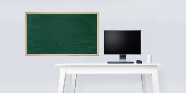 istock Clean white office desk with school blackboard and desktop computer. 1226051332