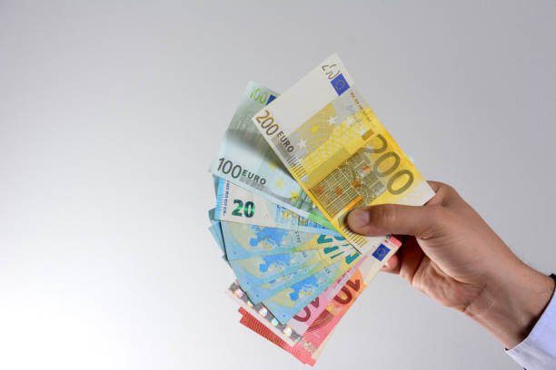 istock Hand with euro currency isolated on grey background. 1226053580