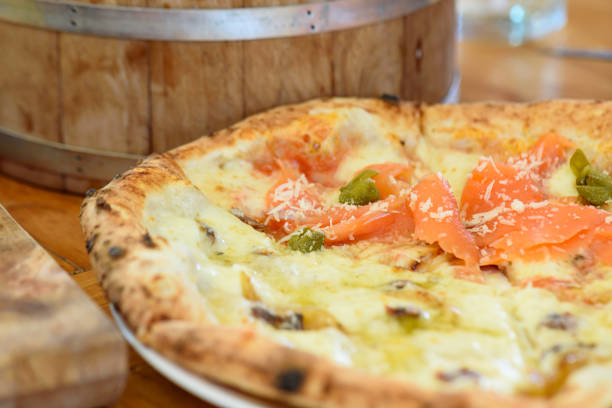 istock Homemade pizza with capers on a wood table 1226054830