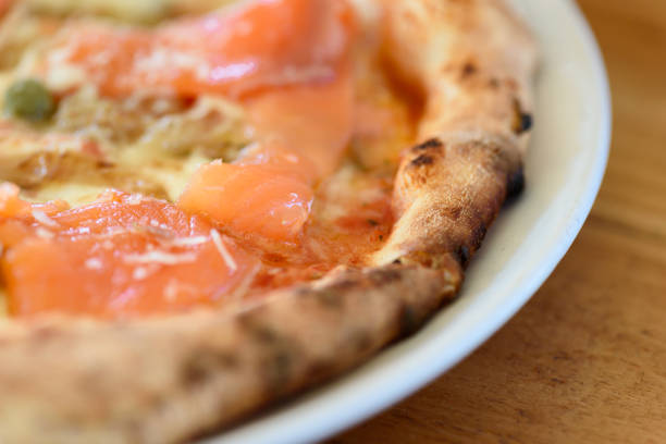 istock Homemade pizza with capers on a wood table 1226054857