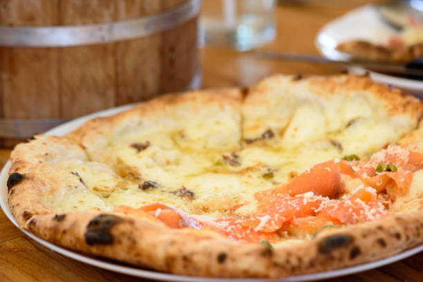 istock Homemade pizza with capers on a wood table 1226054889