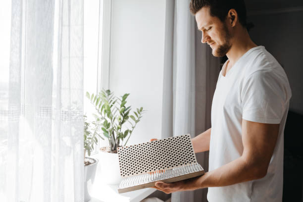 Portrait of man holding in hands bed of nails at morning yoga practice. Man holding in hands bed of nails and preparing for morning yoga practice. Mindfulness and alternative medicine concept. bed of nails stock pictures, royalty-free photos & images