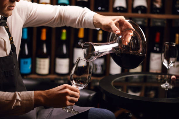 istock Expert decanting and pouring wine into glass. Staff training for sommelier 1226059023