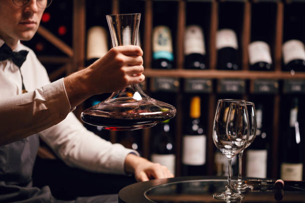 istock Expert decanting and pouring wine into glass. Staff training for sommelier 1226059043