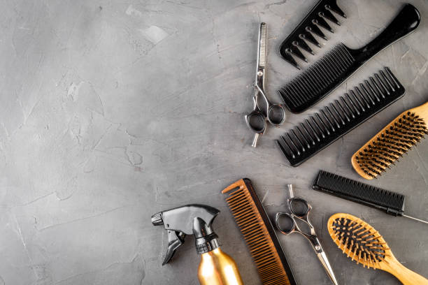 istock Hairdressing instruments. Combs, scissors and spray on grey desk from above frame space for text 1226059282