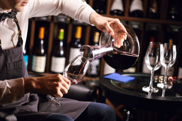 istock Expert decanting and pouring wine into glass. Staff training for sommelier 1226059355