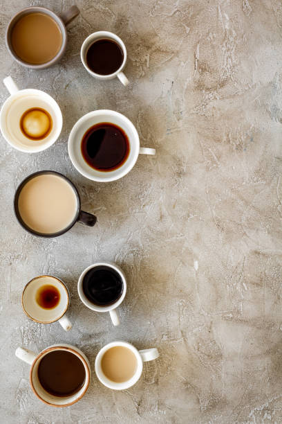 istock Cups of hot drinks on beige background from above frame copy space 1226059430