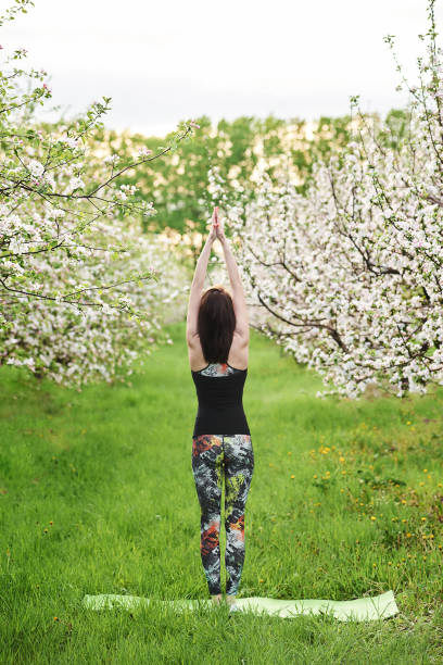 istock Young woman standing on the green lawn 1226059839