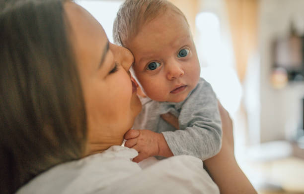 istock Mother breastfeeds and plays with her newborn baby 1226060399
