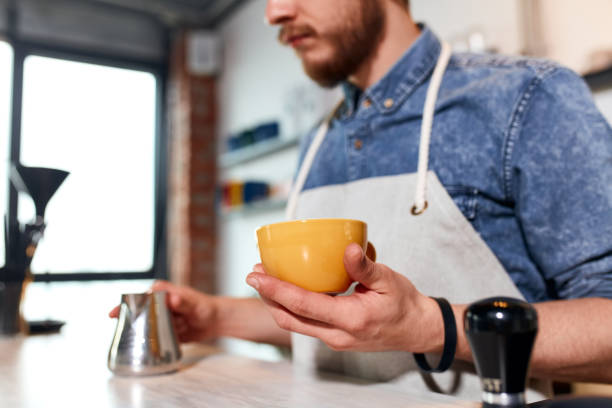 istock Young barista preparing cappuccino in coffee shop 1226060575