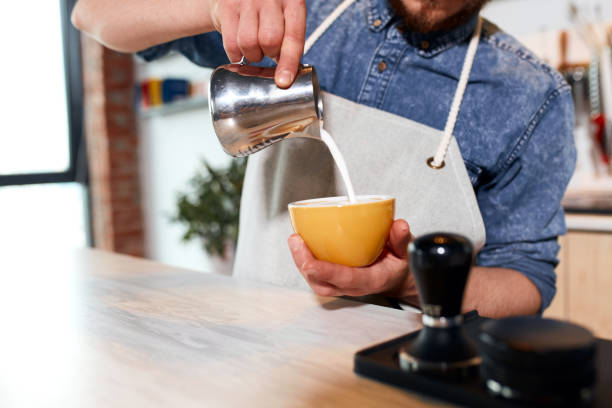 istock Young barista preparing cappuccino in coffee shop 1226060966