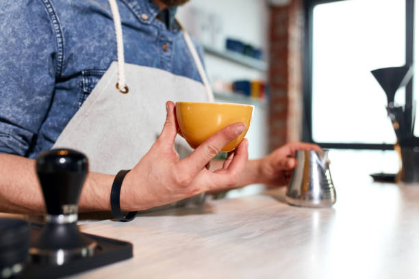istock Young barista makes latte in coffee shop 1226061008