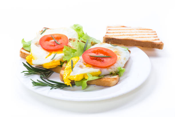 fried toasts with egg, salad, tomato in a plate stock photo