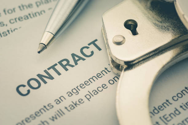 istock Pen and a handcuff on a legal contract form 1226063099