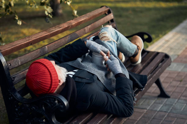 istock Rear view on homeless man lying on bench 1226063728