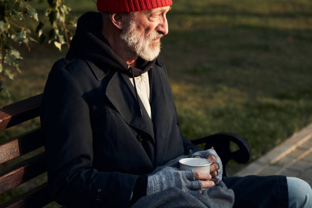 istock Grey bearded old man sit on bench at morning 1226064134