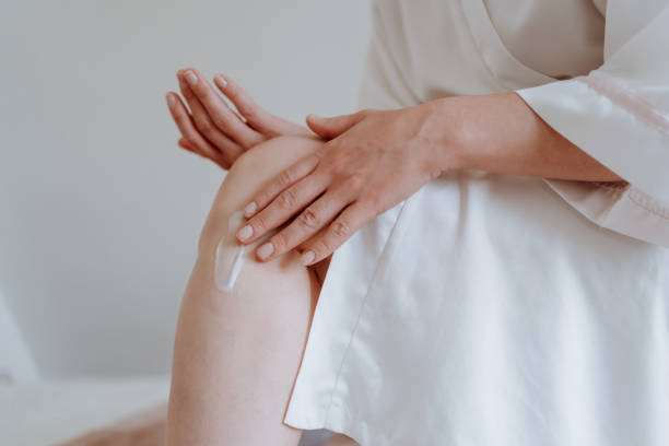 istock Woman applying body cream at home 1226065099