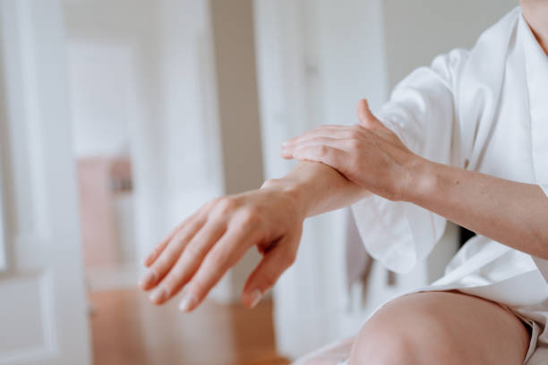 istock Woman applying body cream at home 1226065108