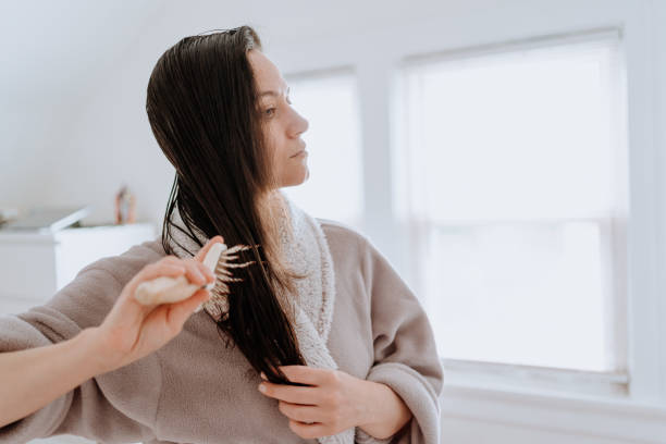 istock Woman combing her hair at home 1226065283