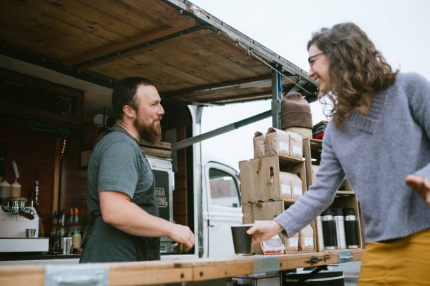 istock Mobile Coffee Truck Owner Preparing Latte For Customer 1226065661