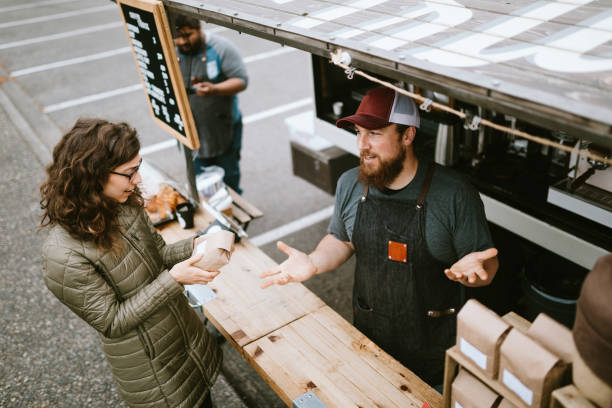 istock Mobile Coffee Truck Owner Explaining Coffee Beans to Customer 1226065670