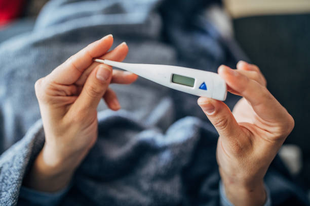 istock Woman thermometer in hands 1226065710
