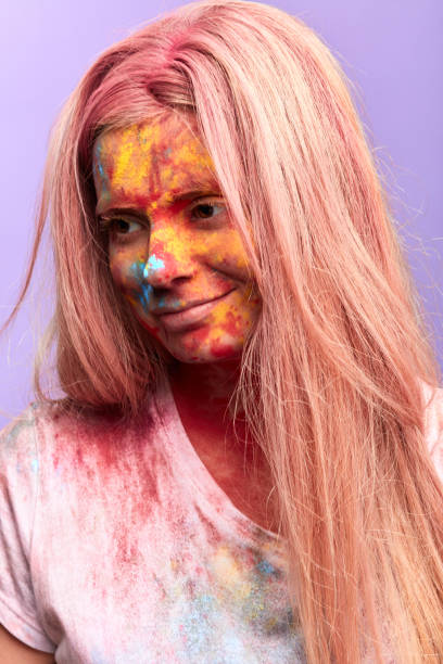 istock happy smiling girl with colorful smeared face looking down 1226065785