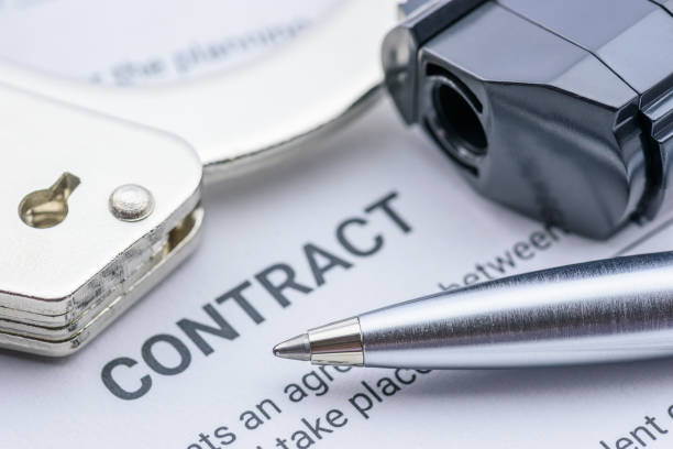 istock Pen, a pistol and a handcuff on a contract form 1226066999