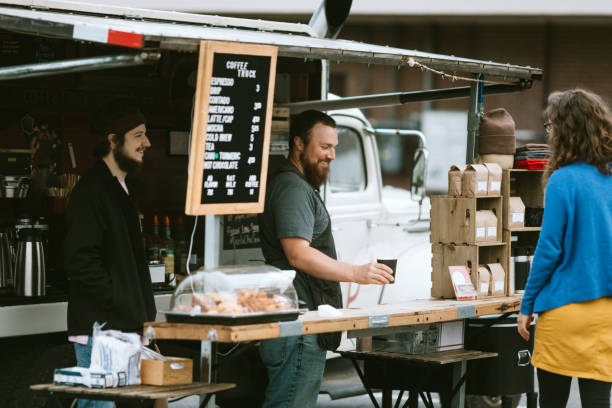istock Mobile Coffee Truck Owner Preparing Latte For Customer 1226067050