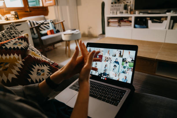 istock Woman is using hand sanitizer while she's having a video call with many people on her laptop 1226067186