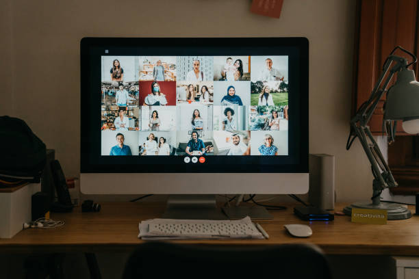 istock Desktop PC with many people having a meeting at distance 1226068254