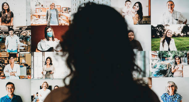 istock Woman having a video conference at home with a big screen 1226068257
