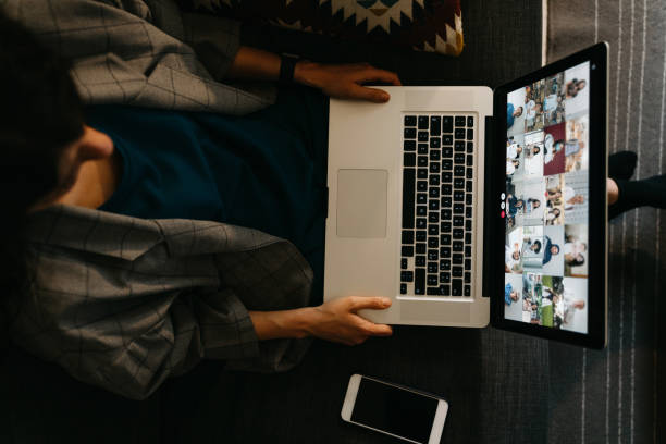 istock Young woman using a laptop on the sofa at home to have a work conference call 1226068268