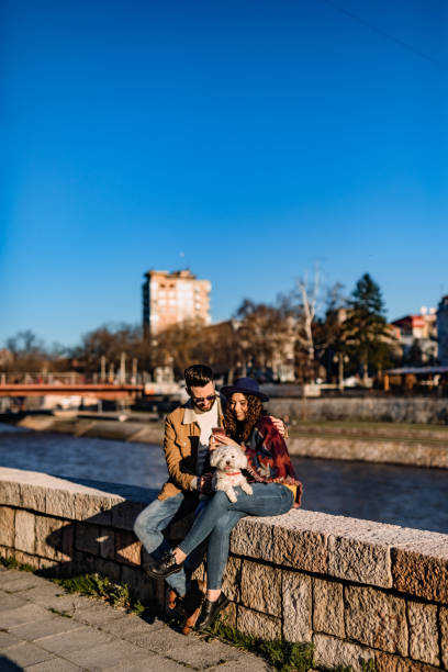 istock Couple with dog enjoying on riverbank 1226070688