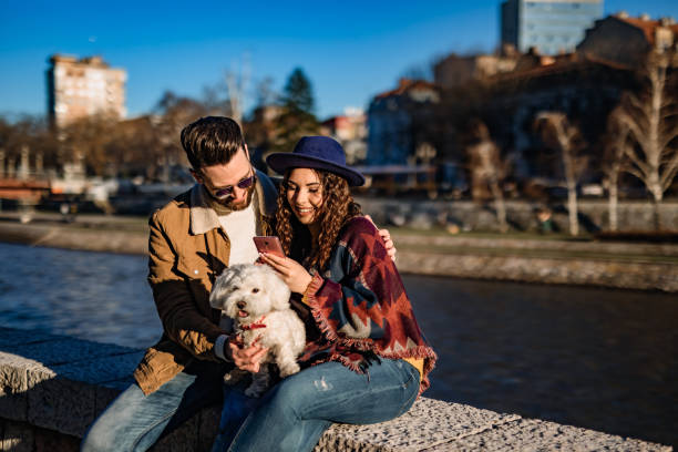 istock Couple with dog enjoying on riverbank 1226070711