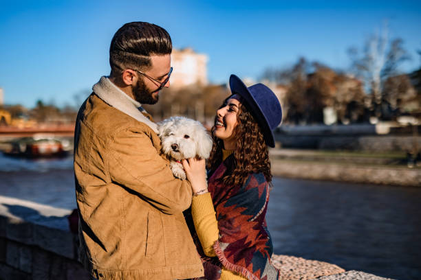 istock Couple with dog enjoying on riverbank 1226070767