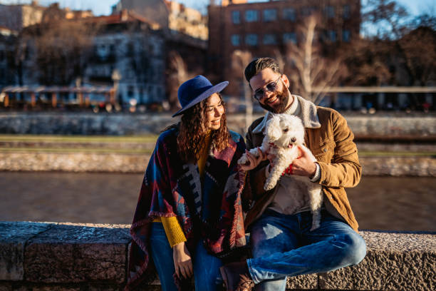 istock Couple with dog enjoying on riverbank 1226070791