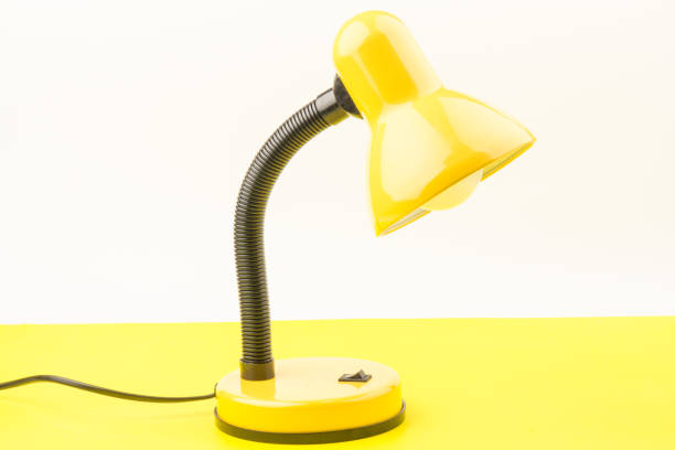 istock Yellow desk lamp isolated on yellow  background 1226071082