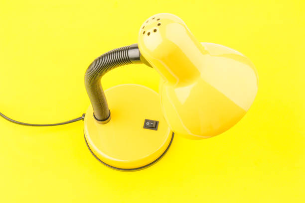 istock Yellow desk lamp isolated on yellow  background 1226071124