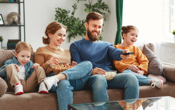 istock Joyful family resting on sofa together 1226072524