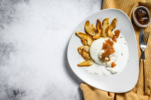 istock Burrata cheese with baked pear and pear marmalade. Gray background. Top view. Copy space 1226073370