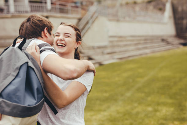 istock High school students smiling and embracing each other 1226073795