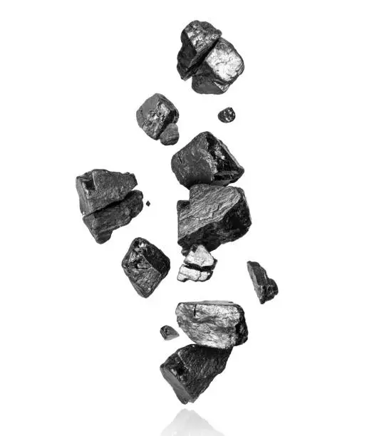 Photo of Pieces of coal are falling down on a white background