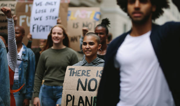istock Group of activists marching and protesting in the city 1226075089