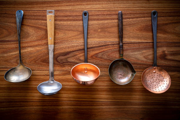 kitchenware arrangement with Ladles on wooden background in a row