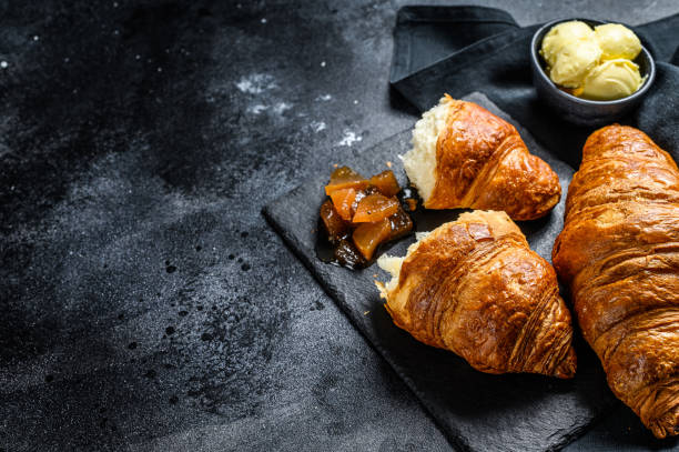 istock Homemade croissants with pear marmalade. Black background. Top view. Copy space. 1226076099