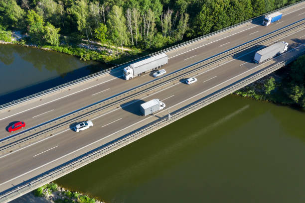 istock Trucks on Highway Bridge, Aerial View 1226077435